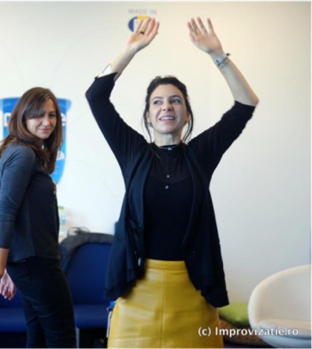 Participantă cu brațele ridicate, postură clasică de statut înalt